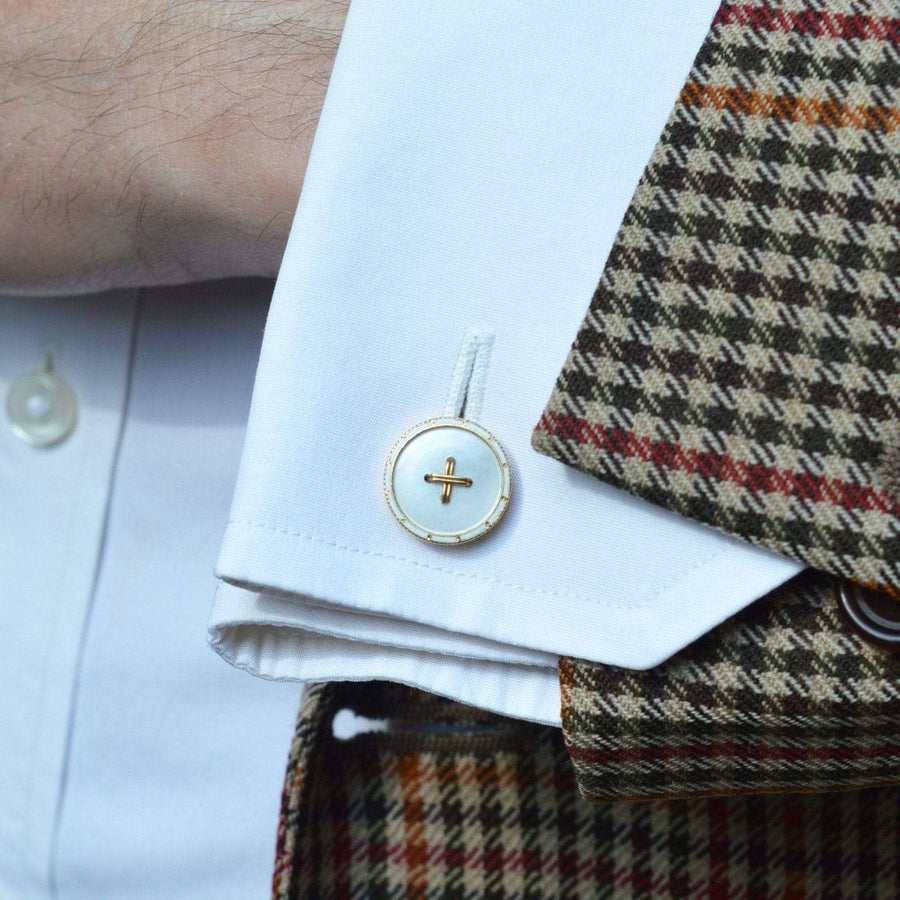 Elegant Edwardian 18ct gold and mother of pearl cufflinks on a crisp white shirt.