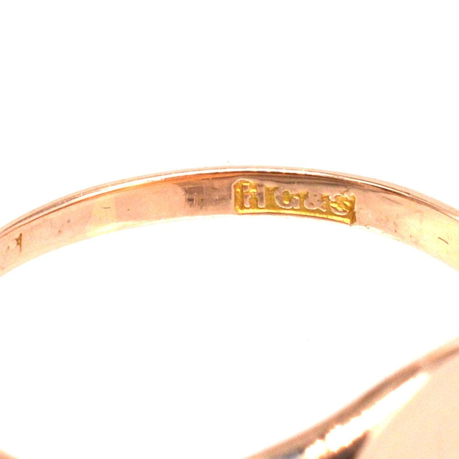 Close-up of the inside of an Edwardian 18ct rose gold signet ring showing the hallmark and craftsmanship.