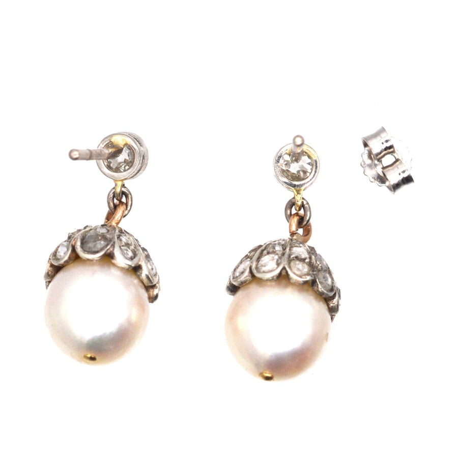 Edwardian 18ct white gold earrings featuring a cultured pearl and rose diamond acorn design.