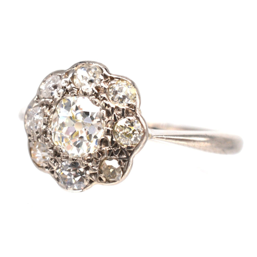 Edwardian 18ct white gold old mine cut diamond cluster ring featuring a central 0.40ct diamond and eight surrounding stones.