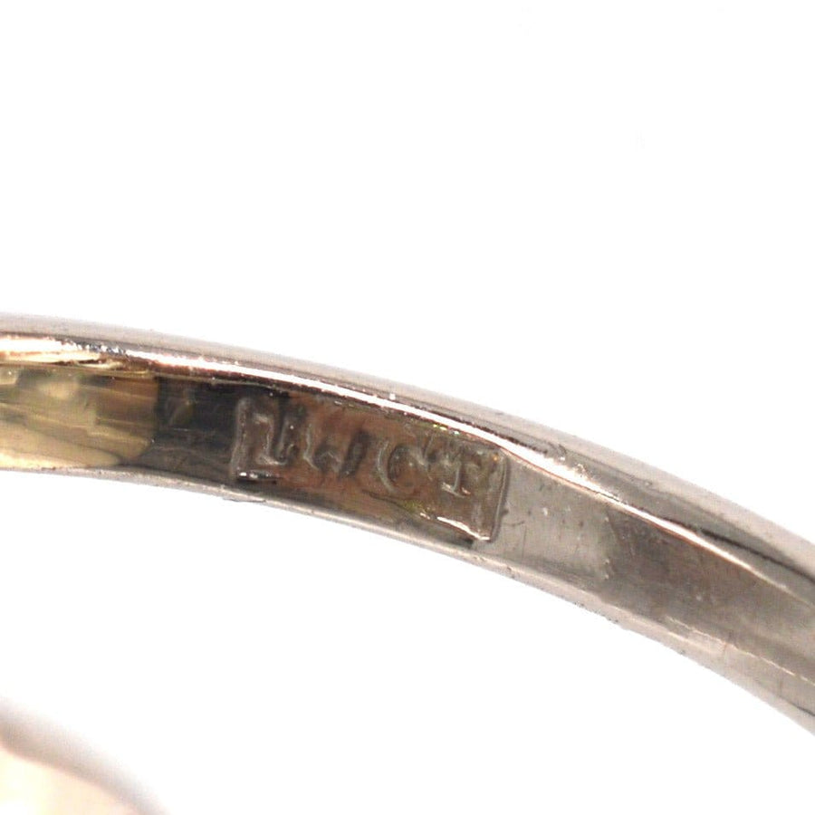Close-up of 18ct white gold ring hallmark, indicating the metal purity and quality.