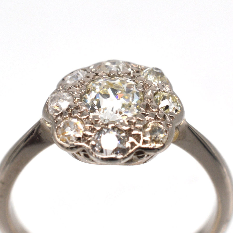 Edwardian 18ct white gold old mine cut diamond cluster ring featuring a 0.40ct central diamond and smaller accent stones.