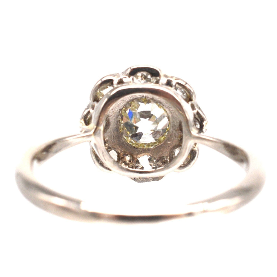 Edwardian 18ct white gold old mine cut diamond cluster ring with a central 0.40ct diamond surrounded by smaller stones.