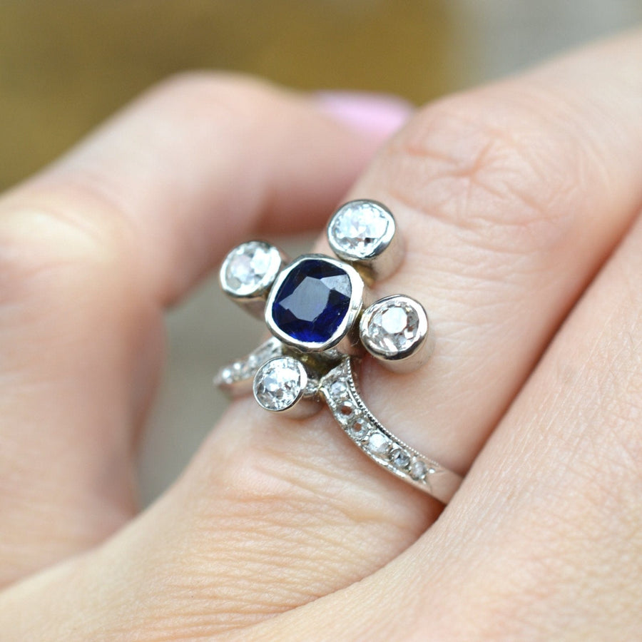 Elegant Edwardian 18ct white gold tiara ring featuring a central sapphire and diamond accents.