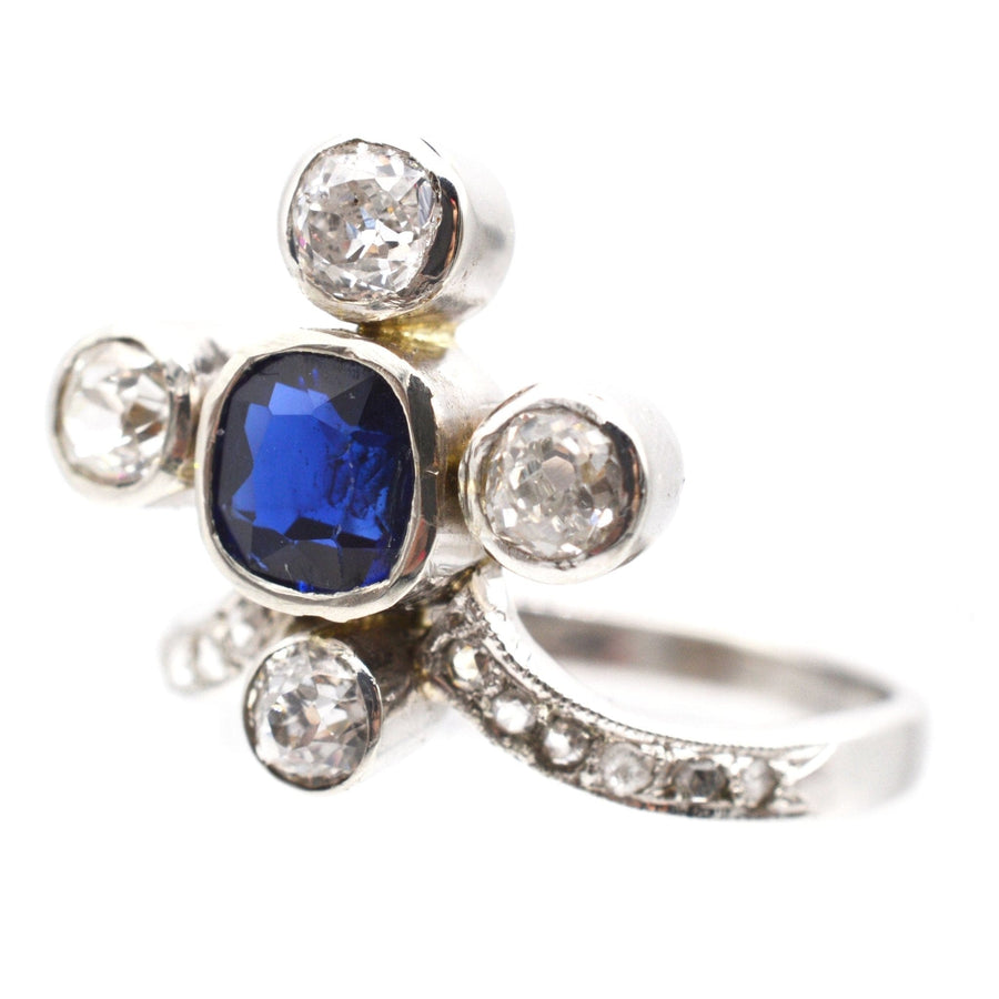 Edwardian 18ct white gold tiara ring featuring a natural blue sapphire and diamond accents.