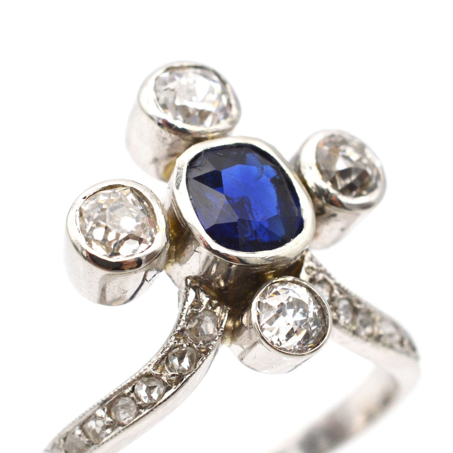 Edwardian 18ct white gold ring featuring a blue sapphire and diamond accents, elegant tiara design.