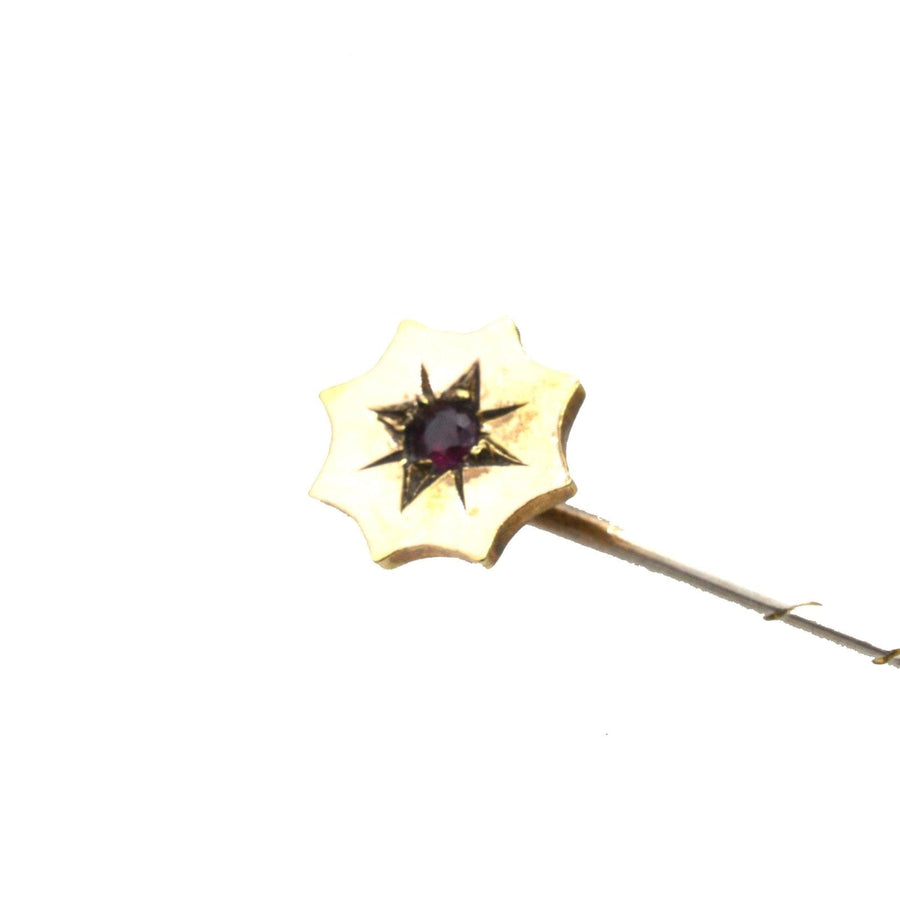 Edwardian 9ct gold tie pin with a ruby center, ideal for enhancing a silk tie's elegance.