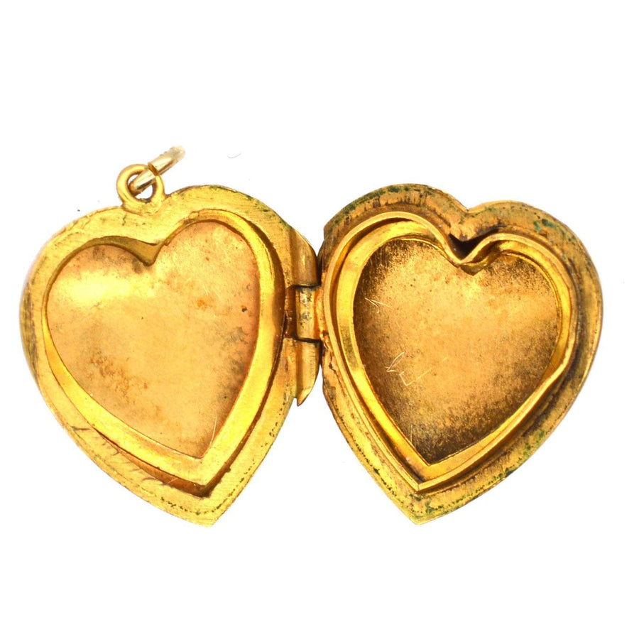Interior view of an Edwardian 9ct gold heart locket pendant with engraved details and two photo spaces.