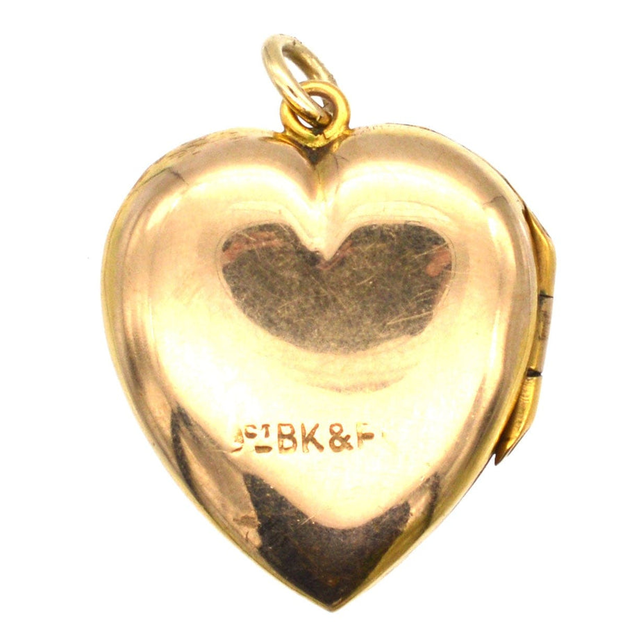 Heart-shaped 9ct gold locket pendant with engraved motifs and '9ct BK&F' marking, dating from 1900-1910.