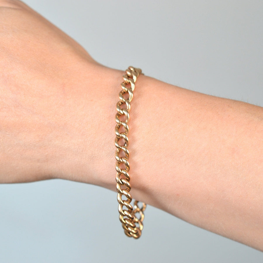 Hand wearing an Edwardian 9ct gold curb bracelet showcasing its bold design and craftsmanship.