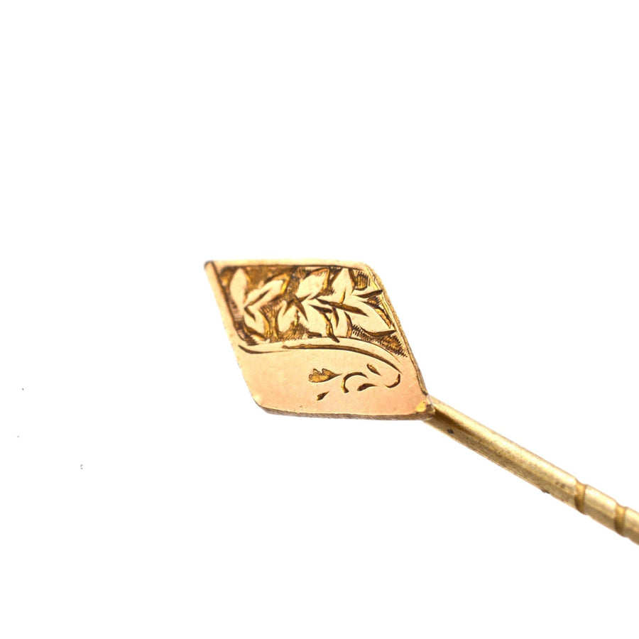 Elegant 9ct gold engraved diamond-shaped tie pin with decorative leaf design, perfect for colorful ties or lapels.
