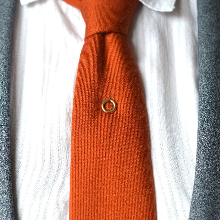 Stylish Edwardian 9ct gold circle tie pin worn on a silk tie, symbolizing timeless elegance and love.