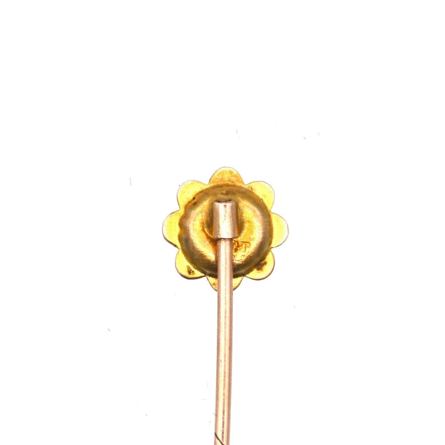 Edwardian 9ct gold flower tie pin featuring a central sapphire, ideal for enhancing a colorful silk tie.