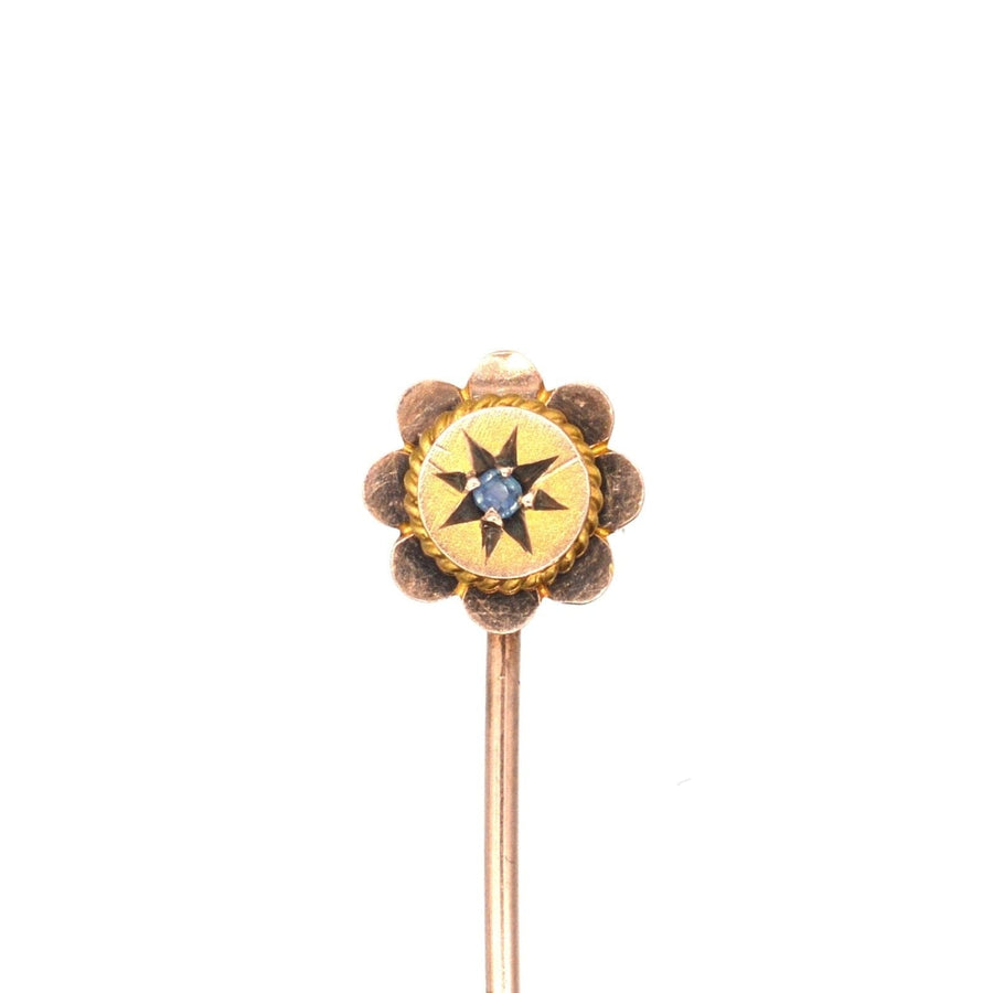 Edwardian 9ct gold flower tie pin featuring a sapphire, perfect for accessorizing colorful silk ties.