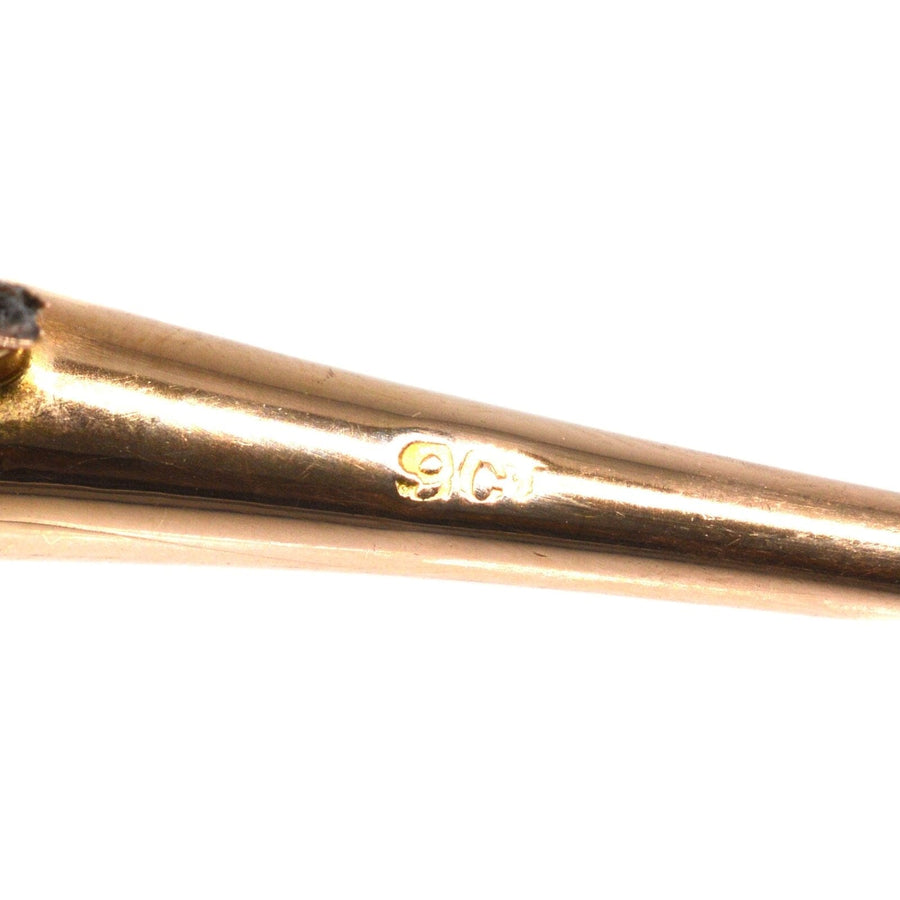 Close-up of the hallmark showing 9ct gold quality on an Edwardian hunting horn brooch.