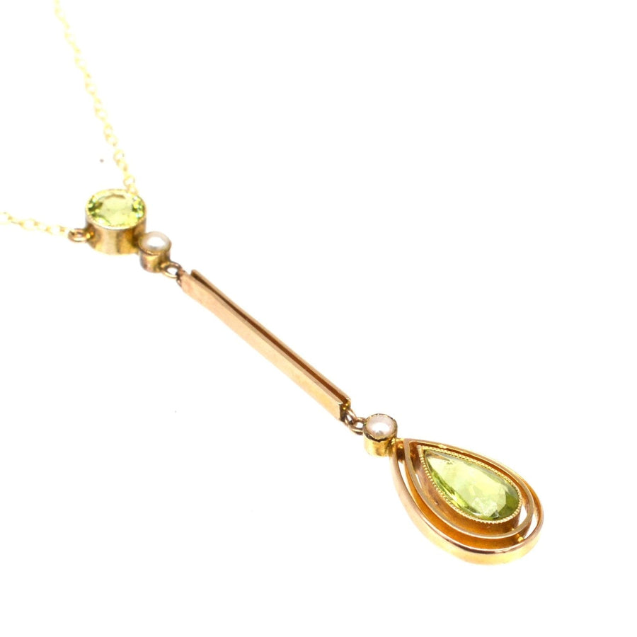 Edwardian 9ct gold pendant necklace featuring olive green peridot and pearl drops, elegantly designed.