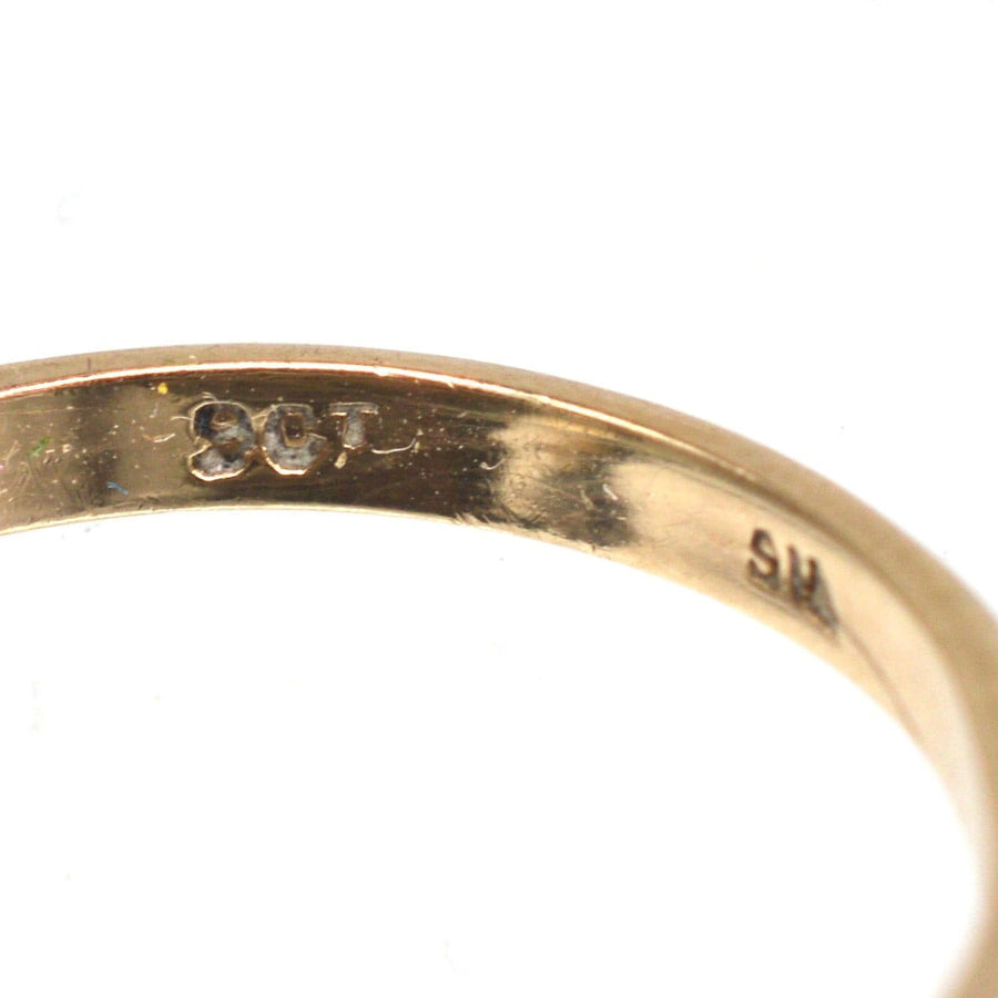 Close-up of the hallmark on an Edwardian 9ct gold ring, showcasing its 9ct gold authenticity and craftsmanship.