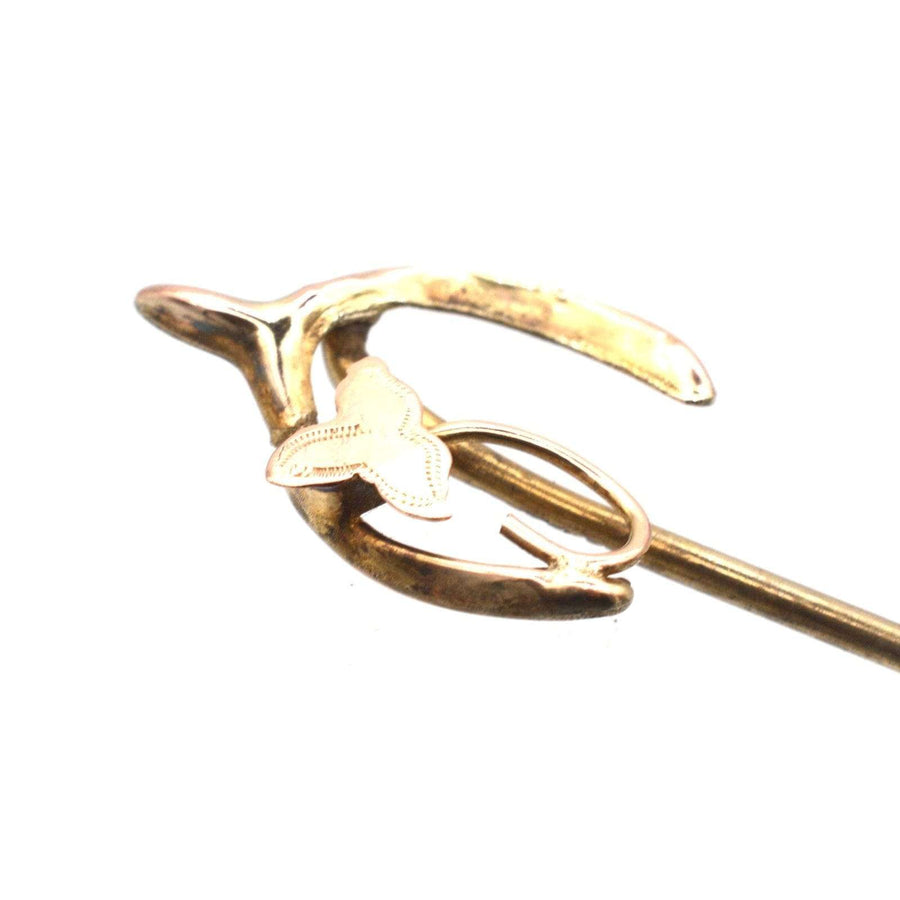 Edwardian 9ct gold wishbone tie pin with ivy leaf, symbolizing love, luck, and fidelity.