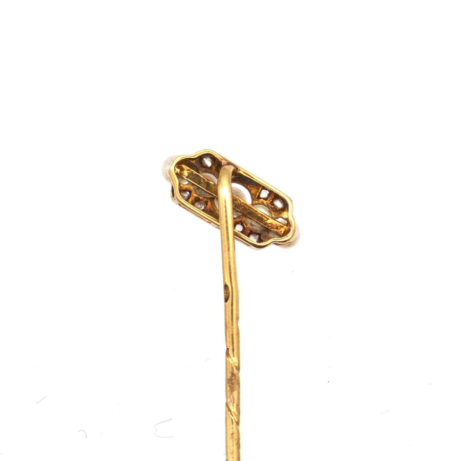 Edwardian tie pin, intricately designed with gold and platinum, featuring a stopper for secure fastening.