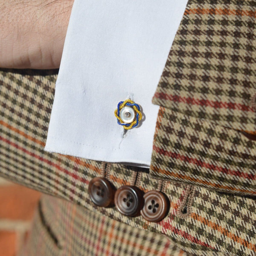 Edwardian mother of pearl and enamel cufflinks showcased on a dress shirt, enhancing classic elegance.