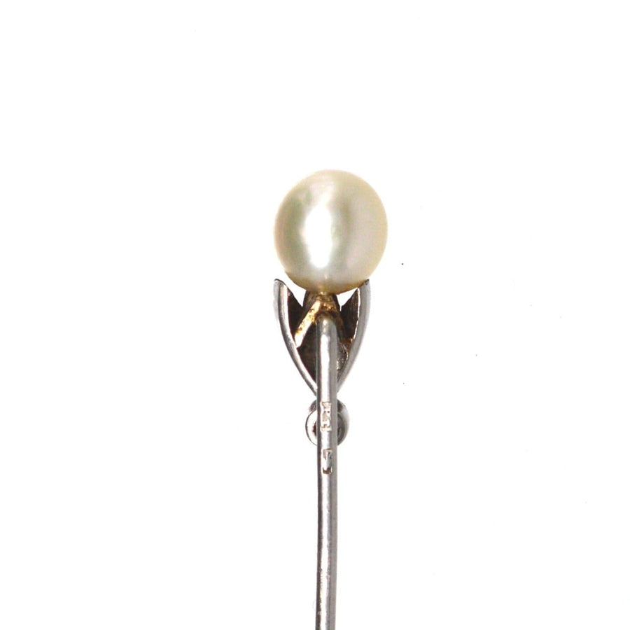Edwardian natural pearl and diamond platinum tie pin with intricately engraved petals and a stunning diamond setting.