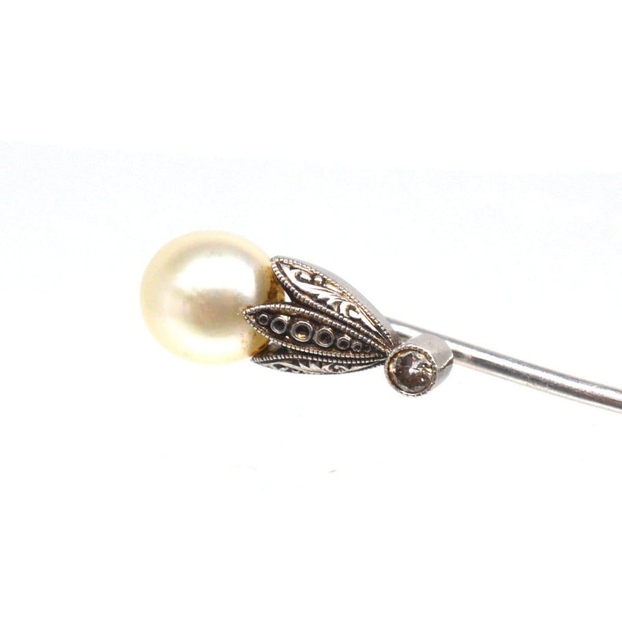 Elegant Edwardian natural pearl and diamond platinum tie pin with intricately-engraved petals, perfect for a silk tie.