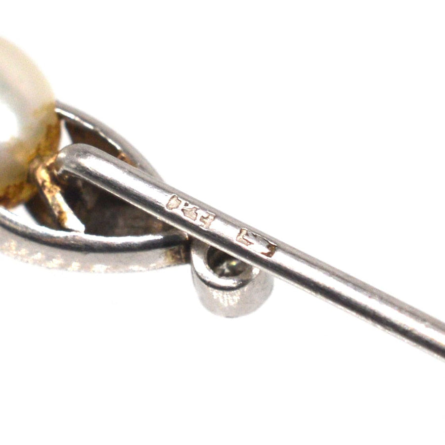 Close-up of an Edwardian natural pearl and diamond platinum tie pin showcasing intricate detailing and hallmark.