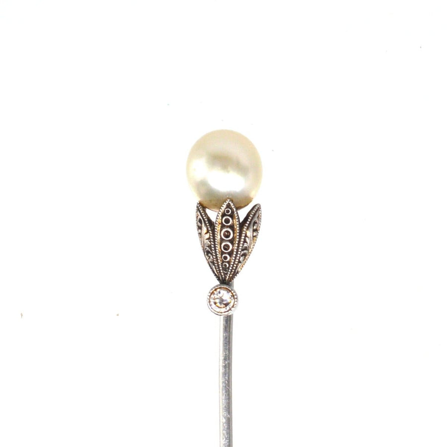 Edwardian natural pearl and diamond platinum tie pin with intricate engraved petals, a true miniature work of art.