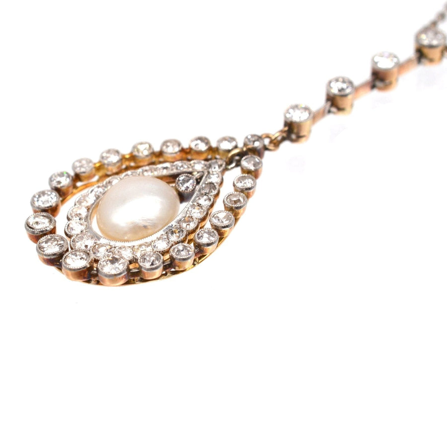 Edwardian pendant featuring a lustrous natural saltwater pearl surrounded by diamonds on a gold chain.