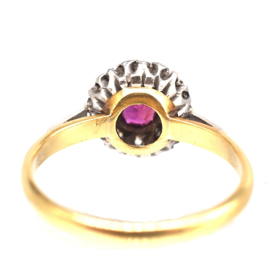 Edwardian Platinum & 18ct Gold ring featuring a natural ruby encircled by diamonds, perfect for engagement.