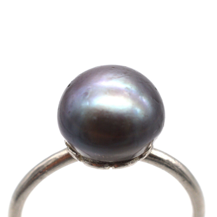 Edwardian platinum ring featuring a natural black saltwater pearl, showcasing exquisite craftsmanship and classic elegance.