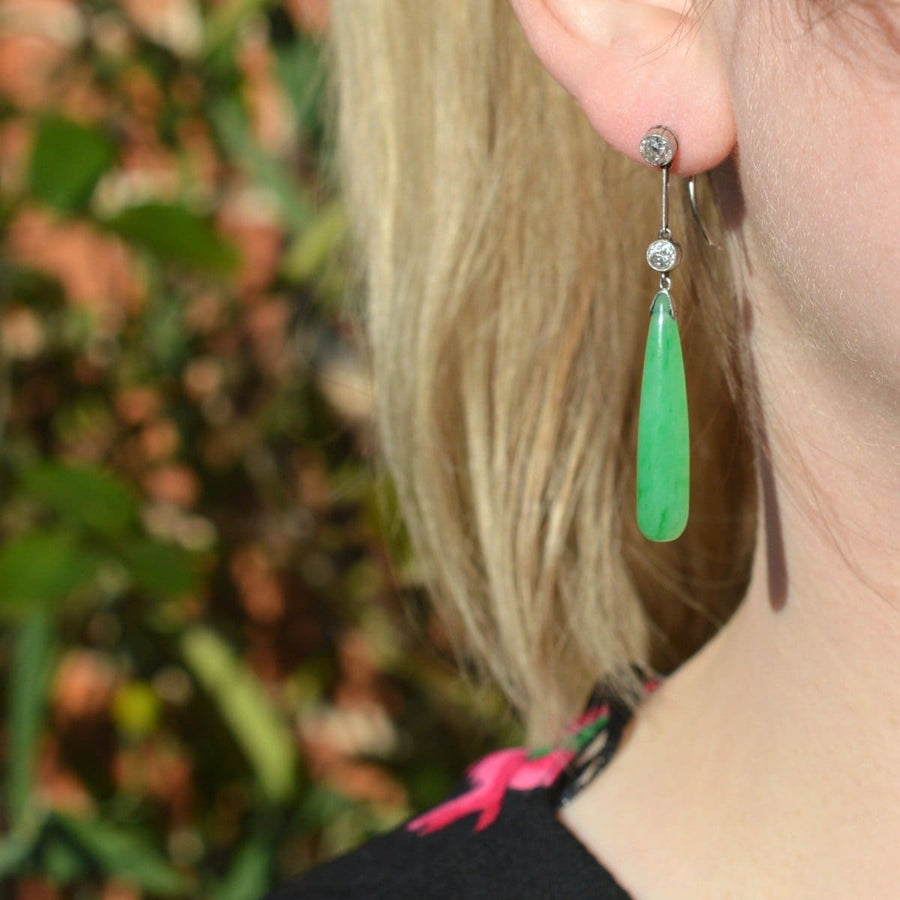 Elegant Edwardian platinum earrings featuring large grade A natural jade drop and diamond accents.