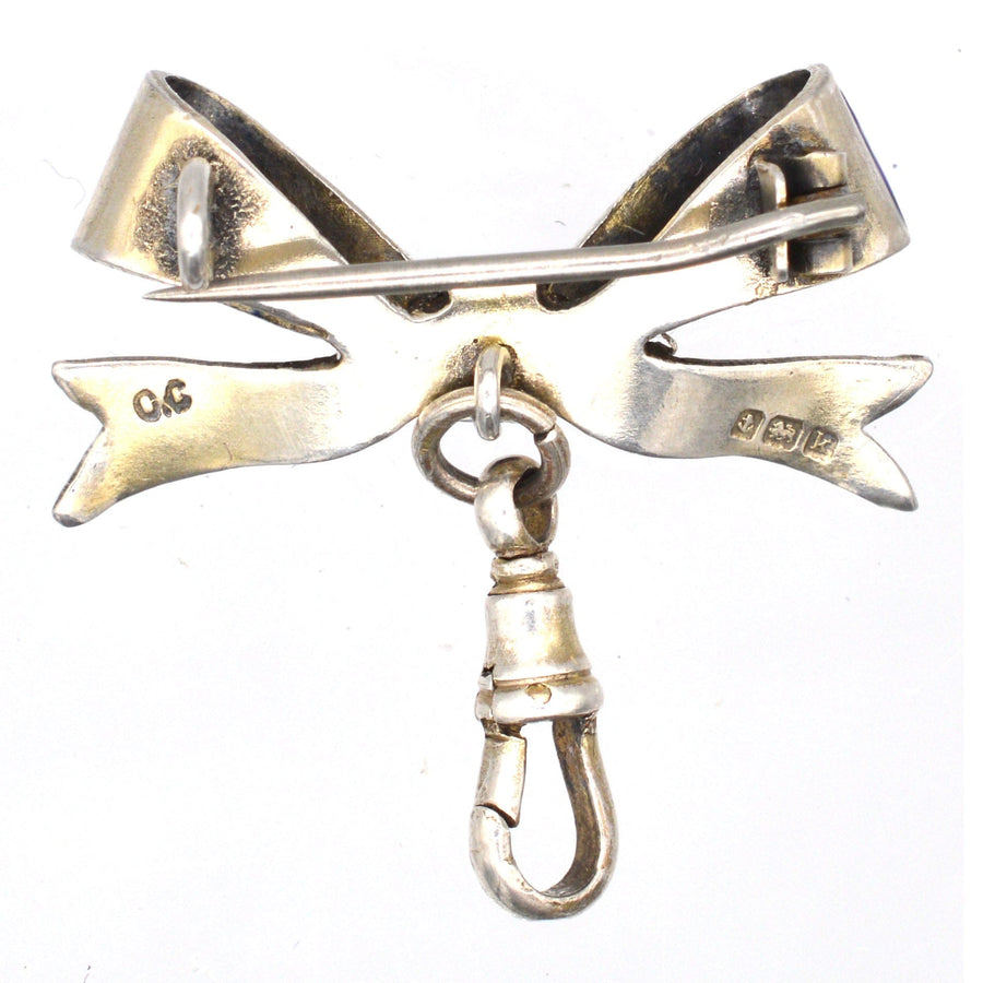 Edwardian silver bow brooch with dog clip, featuring intricate design and assayed Birmingham hallmark from 1909.