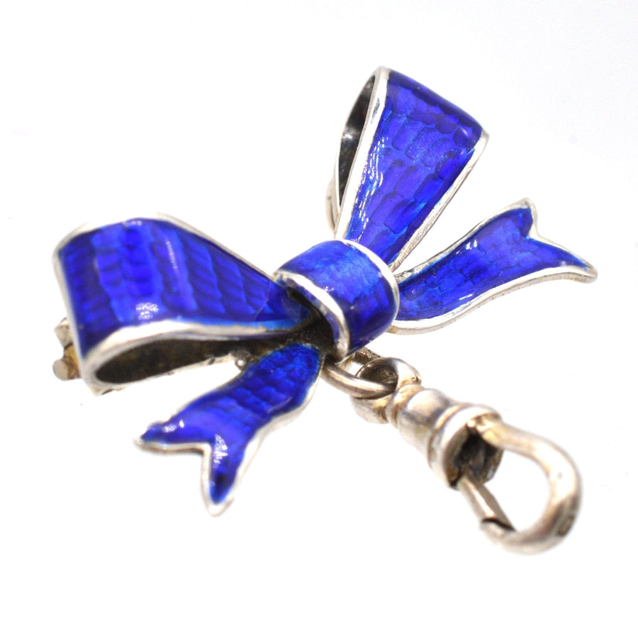 Royal blue guilloché enamel and silver bow brooch with dog clip, crafted in Birmingham, 1909.