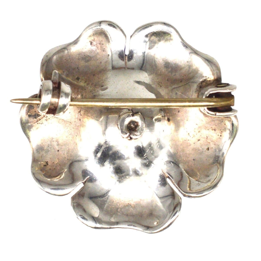 Vintage Edwardian silver flower brooch with blue enamel petals and gold-tone pin, perfect for lapel or hat.