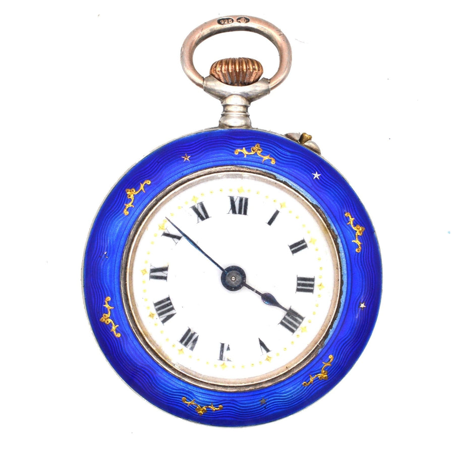Edwardian silver pocket watch with royal blue guilloché enamel, hand-wound mechanical movement, and Roman numerals.