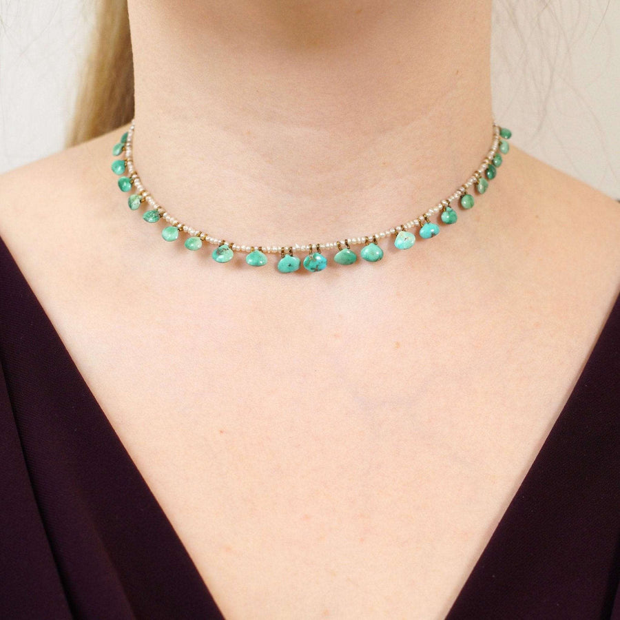 Edwardian turquoise and seed pearl necklace on model, showcasing scallop-shaped turquoise and classic design.