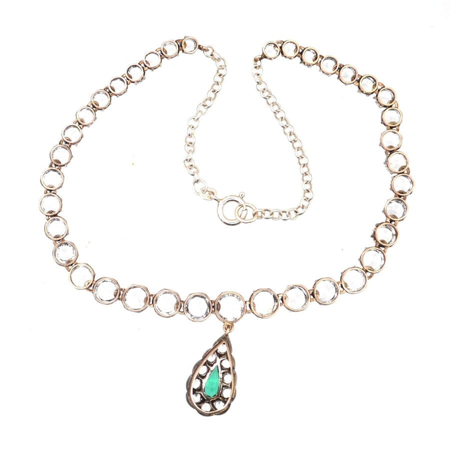 Edwardian silver riviere necklace featuring emerald paste drop, elegant design close to neck, classic jewelry piece.