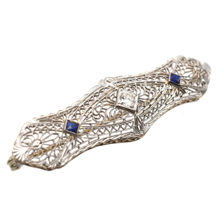 French Art Deco 14ct gold bar brooch with sapphire and diamond in intricate white gold design.