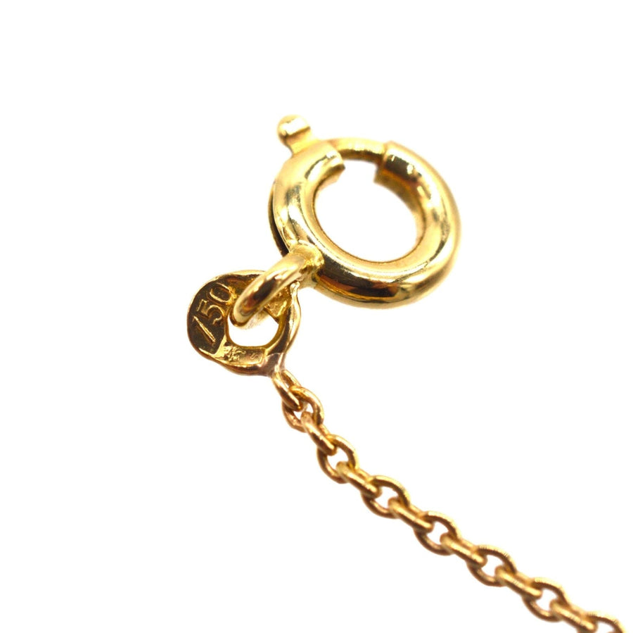 Close-up of 18ct gold necklace clasp with hallmark, highlighting quality craftsmanship.