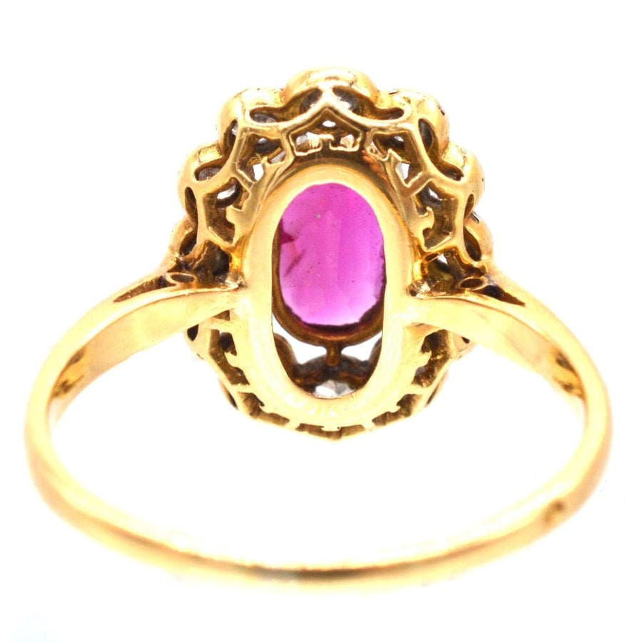 French Belle Epoque ruby and diamond cluster ring showcasing unheated Burma ruby with intricate gold detailing.