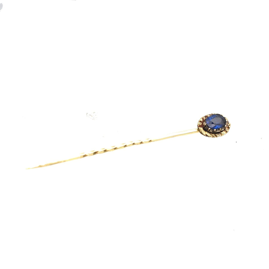 Georgian 15ct gold stickpin featuring natural blue sapphire and ornate repoussé work, perfect for silk ties.