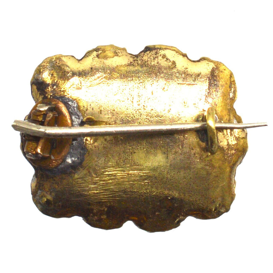 Back view of a Georgian brooch featuring vintage gold detailing and a classic pin closure.