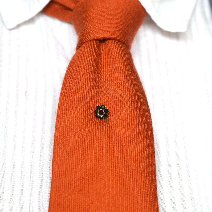 Georgian Regency 9ct gold Vauxhall Glass tie pin on an orange tie, showcasing historical elegance from the 1800s.