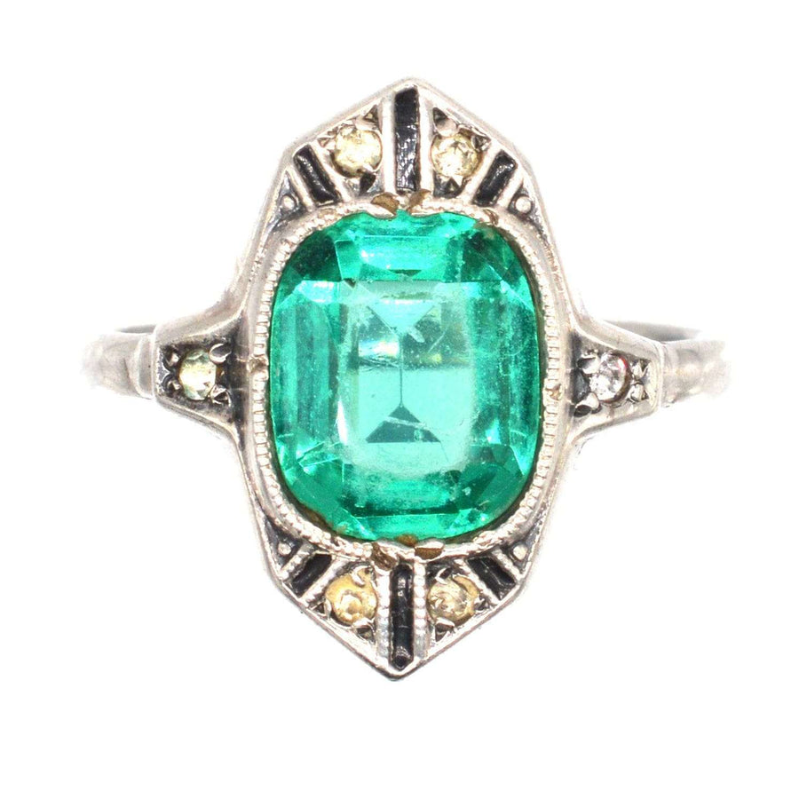 German Art Deco silver ring featuring emerald green paste, white diamond paste, and black enamel design.