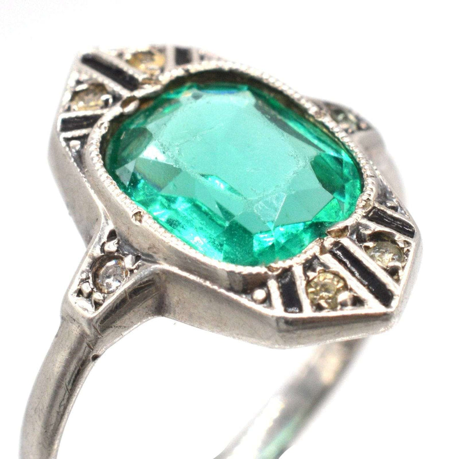 German Art Deco cocktail ring featuring large emerald green stone and white diamond paste accents.