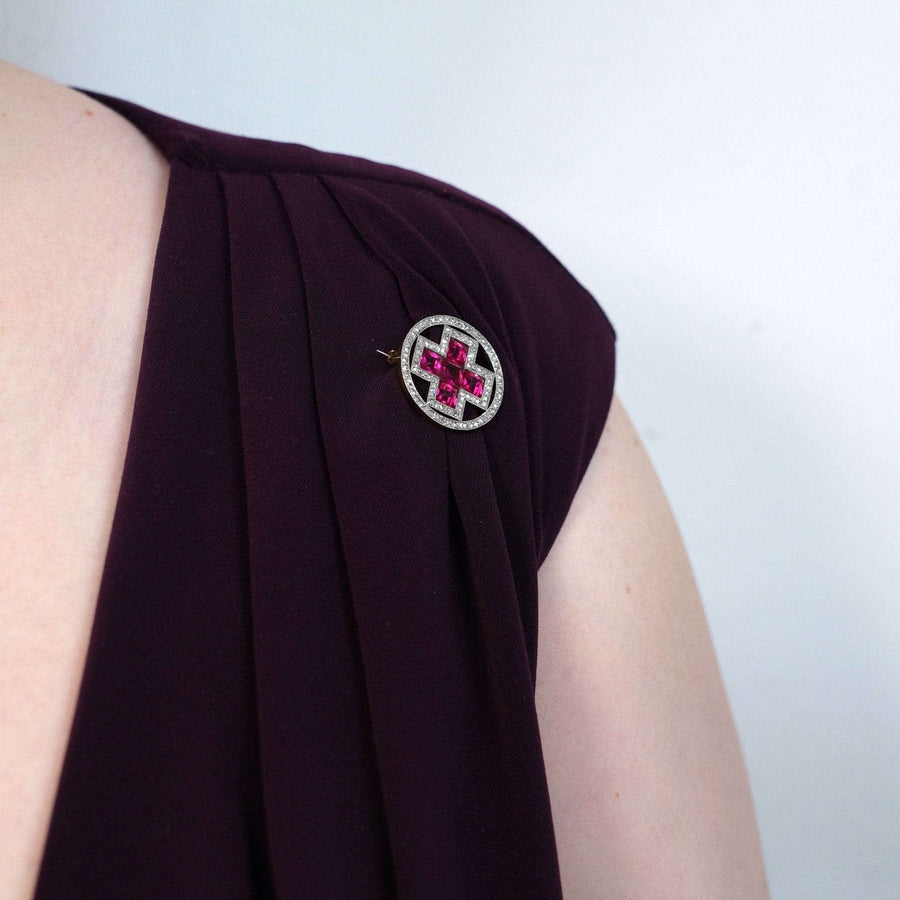 Imperial Russian brooch featuring synthetic rubies and diamonds, worn on a woman's shoulder.