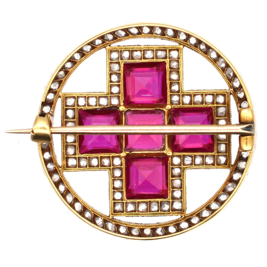 Imperial Russian 1910s brooch featuring synthetic rubies and diamonds in a cross design.