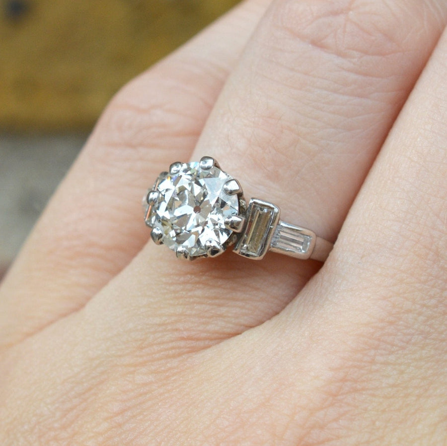 Large Art Deco platinum ring with 3 carat Old European cut diamond and baguette shoulder diamonds.