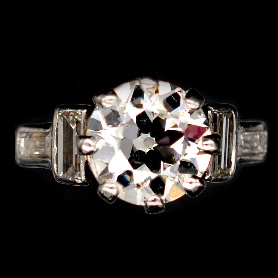 Large Art Deco platinum ring featuring a 2.3 carat Old European cut diamond with baguette diamond shoulders.